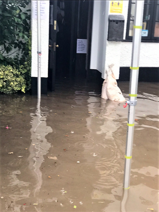Flood water pours into the Star Inn.